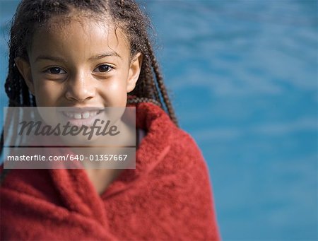 Portrait of a girl wrapped in a towel and smiling