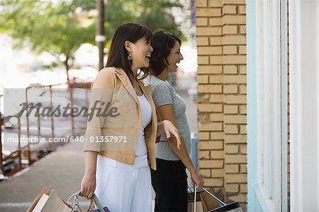 Young woman with an adult woman carrying shopping bags