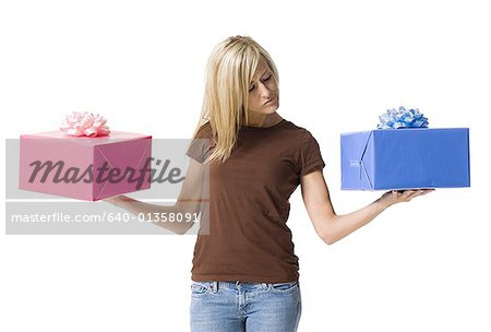 Young woman holding two gifts