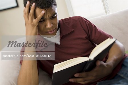 High angle view of a man reading a book