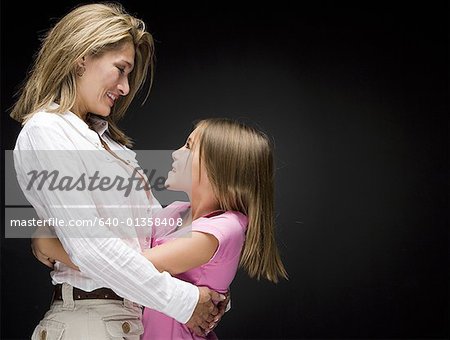 Portrait of a mother and daughter hugging