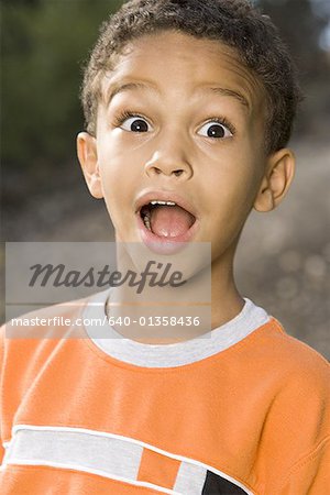 Portrait of a boy with his mouth open