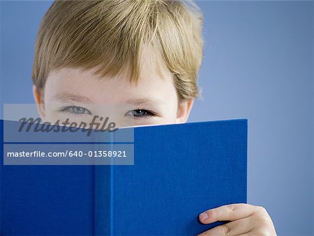Boy reading hardcover book