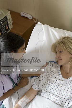 High angle view of a female doctor comforting a female patient