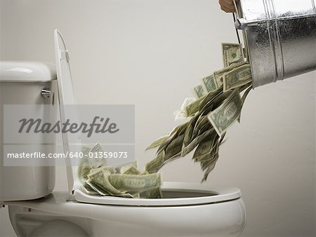 Person dumping money into a toilet bowl