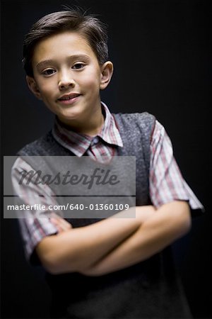 Portrait of a boy smiling with his arms crossed