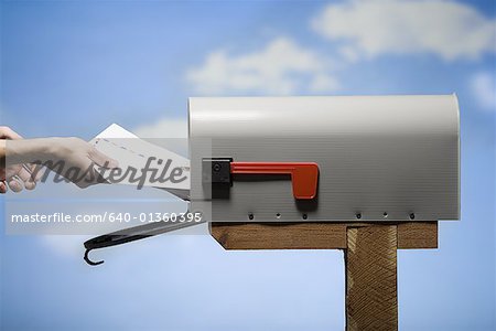 Woman getting mail from letterbox