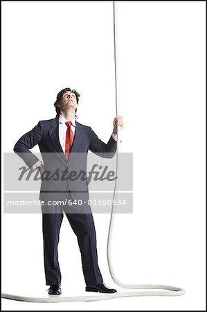 Businessman holding a rope