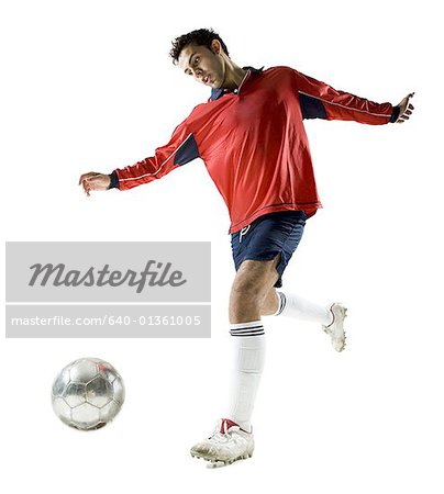Low angle view of a young man playing with a soccer ball