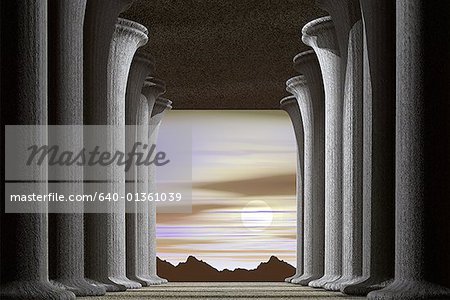 View of the sun and mountains through a hallway of pillars