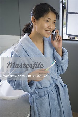 High angle view of a mid adult woman talking on a mobile phone in the bathroom