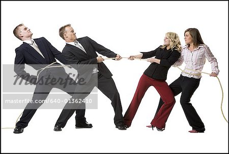 Business people engaged in a tug of war contest