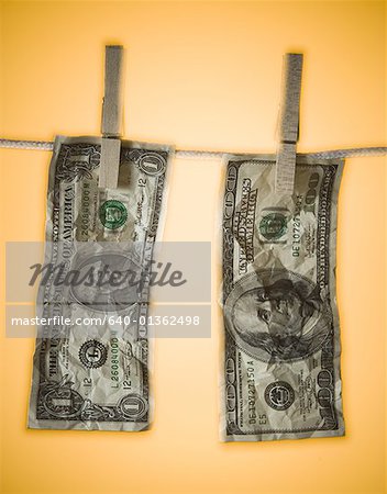 Close-up of money hanging on a clothes line