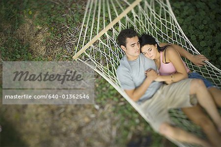 High angle view of a young couple sleeping in a hammock