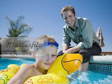 Father and son at swimming pool