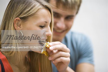 feeding boy with girl