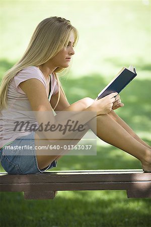 Profile of a young woman reading a book