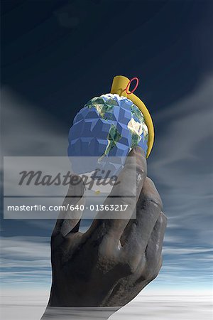 Low angle view of a grenade- shaped globe in a person's hand