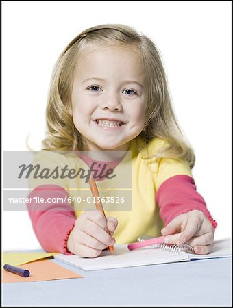 Portrait of a girl coloring with crayons
