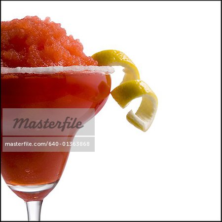 Red slush beverage in cocktail glass with lemon garnish