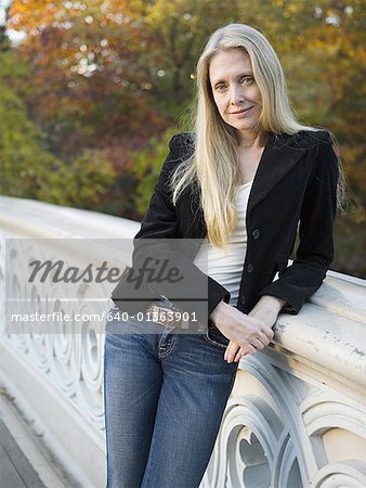 Portrait of a woman leaning against a banister