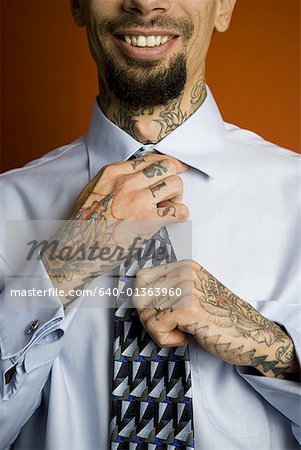 Businessman with tattoo fasten necktie Stock Photo by silverkblack 1450257