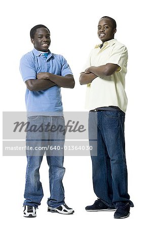 Portrait of two brothers standing with their Arms Crossed