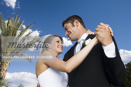 Low angle view of a newlywed couple dancing
