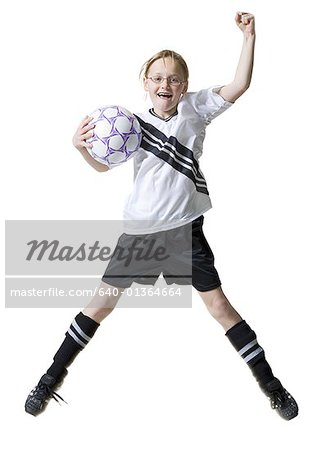 Portrait of a girl jumping with a soccer ball
