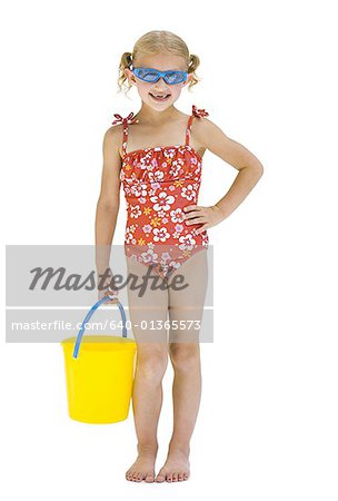 Young sisters on vacation playing with a beach ball