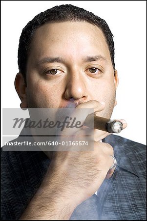 Portrait of a mid adult man smoking a cigar