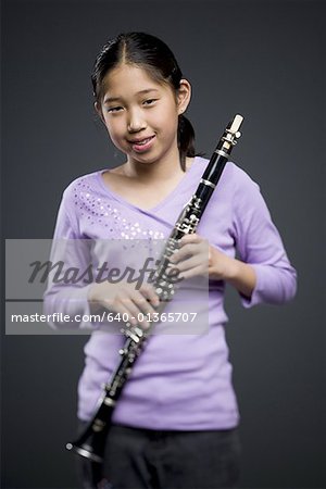 Portrait of a teenage girl holding a clarinet
