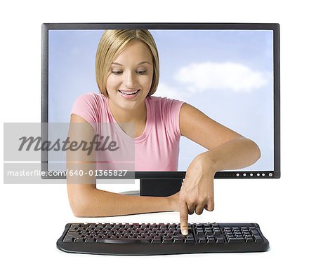 Young woman in desktop computer monitor pressing button on keyboard