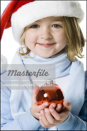 Portrait of a girl holding a Christmas ball