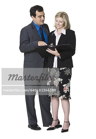 Businessman and a businesswoman looking over paperwork