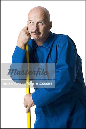 Close-up of a mature man holding a stick