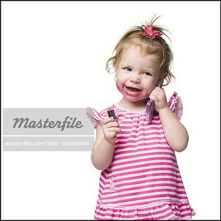 Young girl with lipstick on face smiling