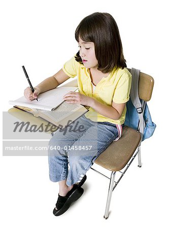 Girl at school desk doing written work