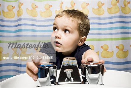 Boy in bathroom at sink