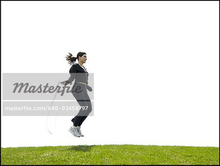 Woman skipping rope outdoors