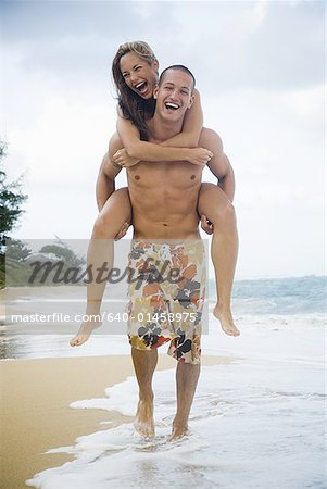 Young Man Giving Woman Piggyback Outdoors, Stock image