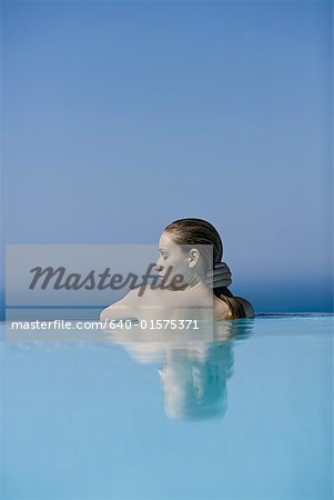 Profile of woman in pool outdoors