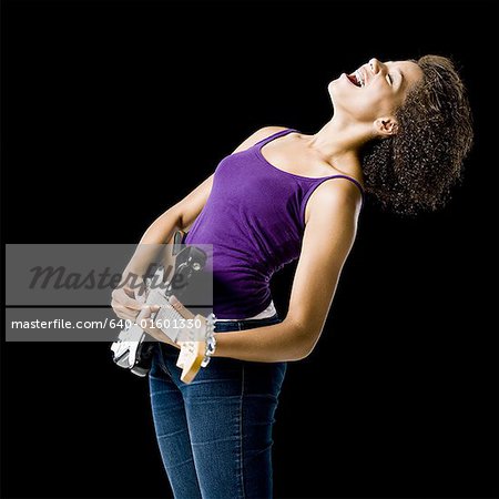 Girl playing electric guitar and singing