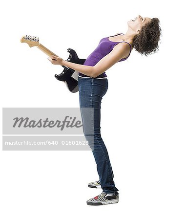 Girl playing electric guitar and singing