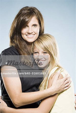 Mother and daughter embracing and smiling