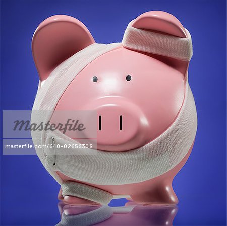 Piggy bank with bandages holding it together.