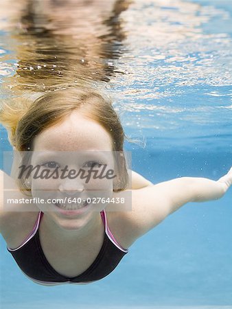 Portrait of a girl swimming underwater