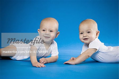Identical twin babies crawling