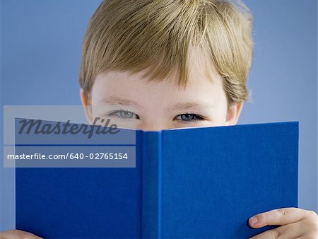 Boy reading hardcover book