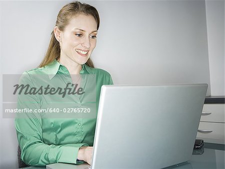 Profile of a woman using a laptop